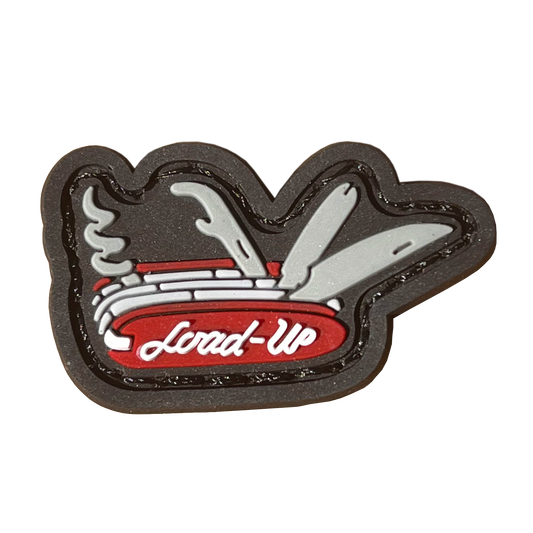 A red and gray patch resembling a swiss army knife multitool; a screw, pry bar, and knife stick up.the word 'Load-Up' is written on the knife.