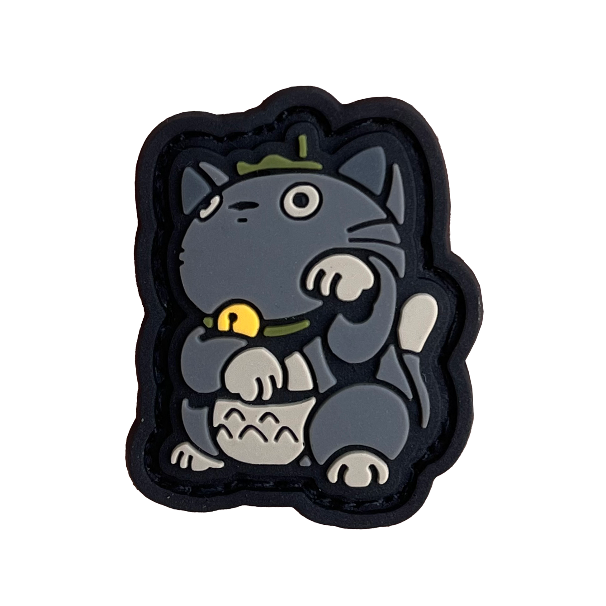 A gray cat in the neko (lucky cat) pose resembling Totoro from Studio Ghibli.